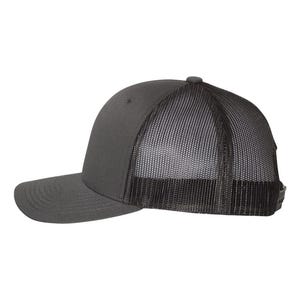 May include: A charcoal gray trucker hat with a curved brim and a mesh back. The hat features a solid front panel and a snapback closure for an adjustable fit. The mesh back provides ventilation.