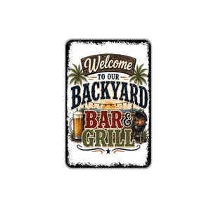 May include: A rectangular metal sign with a white background and distressed edges. The text reads Welcome to our BACKYARD BAR & GRILL. The design features two palm trees, a glass of beer, a charcoal grill, and string lights against a sunset.