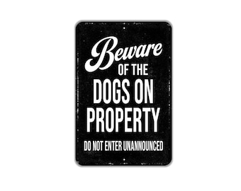 May include: A rectangular black metal sign with white text that reads Beware of the DOGS ON PROPERTY DO NOT ENTER UNANNOUNCED. The sign features a distressed, weathered texture with rounded corners and small mounting holes at the top and bottom.