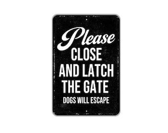 May include: A rectangular black metal sign with white text that reads Please CLOSE AND LATCH THE GATE DOGS WILL ESCAPE. The sign features a distressed, weathered texture along the edges and has small mounting holes at the top and bottom center.
