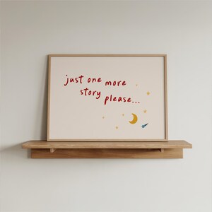 a framed poster with the text "Just one more story please..." and a small illustration of a crescent moon and stars.