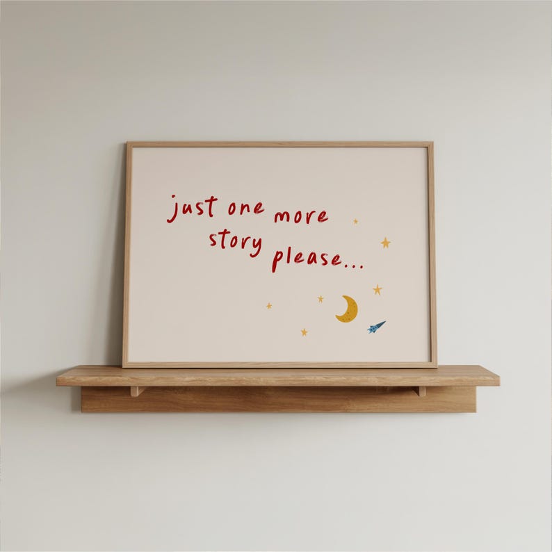 a framed poster with the text "Just one more story please..." and a small illustration of a crescent moon and stars.