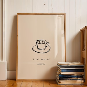 May include: A framed wall art print featuring a minimalist black line drawing of a coffee cup with heart latte art on a beige background. Below the cup, the text reads FLAT WHITE, followed by the words espresso and steamed milk in smaller font.
