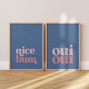 May include: Two framed prints with a blue background and pink text. The left print says "nice bum" and the right print says "oui oui".