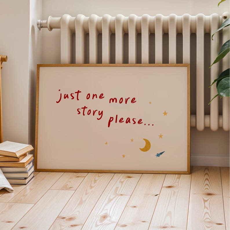 A framed poster with the text "Just one more story please..." and a small illustration of a crescent moon and a shooting star.