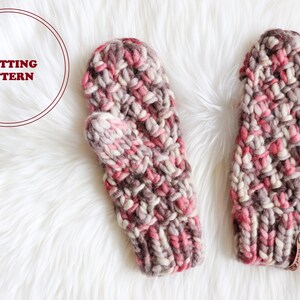 May include: A pair of pink, brown, and white knitted mittens with a leather tag that says "Knit" on one mitten.  Knitting pattern.