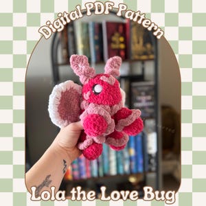 May include: A crochet pattern for a pink and white love bug amigurumi. The pattern is called "Lola the Love Bug" and is available as a digital PDF download.