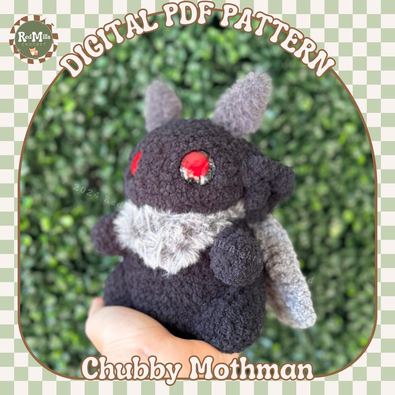 May include: A plush toy in the shape of a mothman, with a black and gray fuzzy body, red eyes, and gray wings. The toy is being held in a hand against a green leafy background. The text "Chubby Mothman" is printed below the toy.