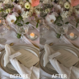 May include: A white table setting with a white tablecloth, two white plates, two gold forks, two white napkins, two clear glass candle holders with white candles, and a bouquet of pink and white flowers.