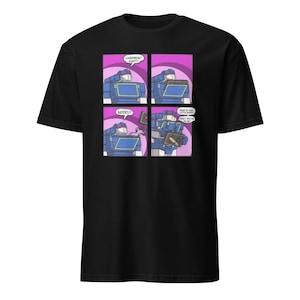 May include: Black t-shirt featuring a comic strip with a blue robot character. The comic strip shows the robot in four panels with speech bubbles. The text in the speech bubbles reads "LASERBEAK! EJECT!", "NOOO!!", and "WHAT IN THE LITTLE ROBOTS DON'T YOU DO IN ME?!"