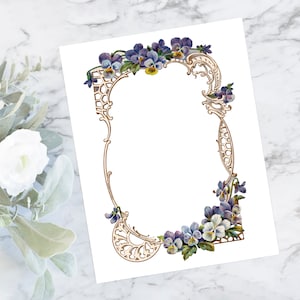 May include: A vintage floral frame with a white background. The frame is decorated with purple and yellow pansies and intricate gold scrollwork.