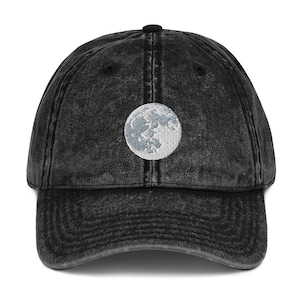 Full moon embroidered onto black denim cap. Adjustable size with buckle in back