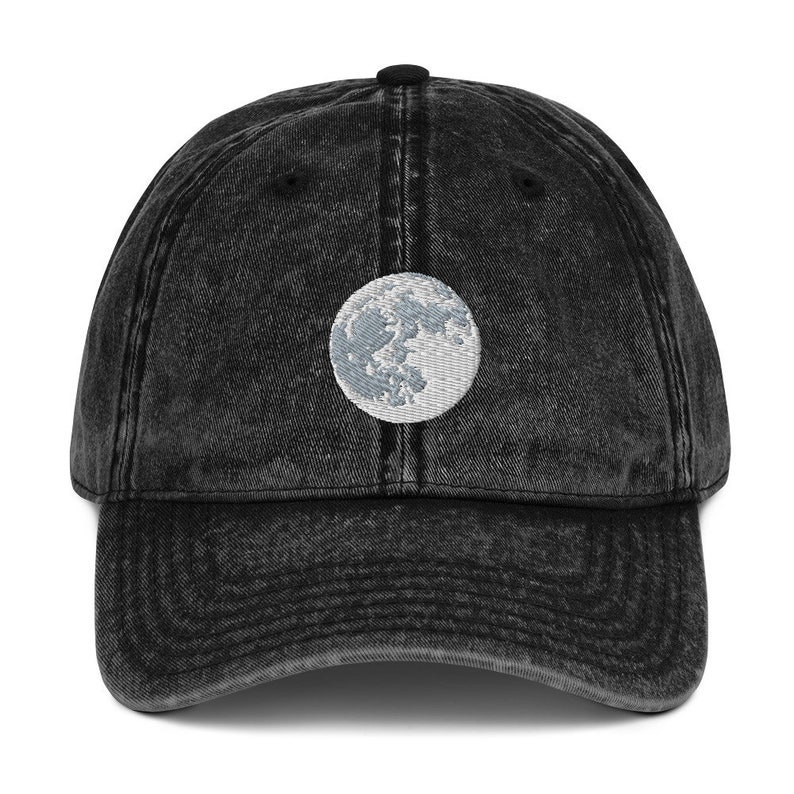 Full moon embroidered onto black denim cap. Adjustable size with buckle in back