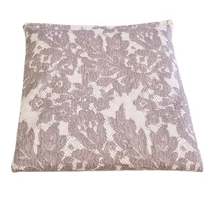 May include: A square throw pillow with a white background and a gray lace pattern.