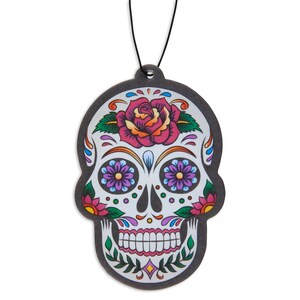 May include: A black and white sugar skull car air freshener with colorful flowers and a pink rose.