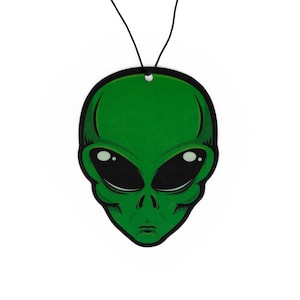 May include: Green alien head car air freshener with black eyes and a string for hanging.