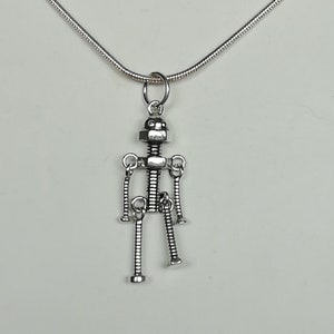 May include: Silver necklace with a robot pendant made of screws and nuts.