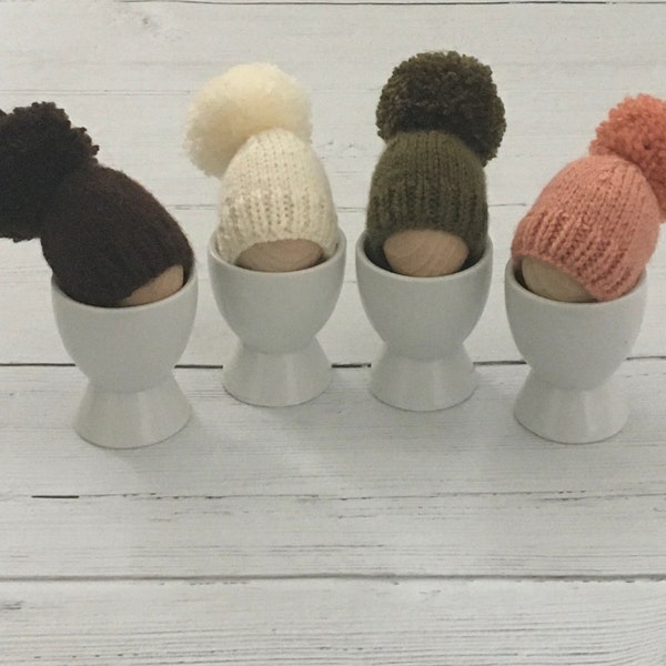 Set of four hand knitted egg cosies