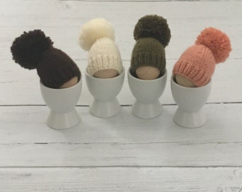 Set of four hand knitted egg cosies