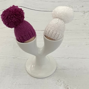 Set of two knitted egg cosies-plum and white