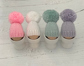 Set of four hand knitted egg cosies-pastels