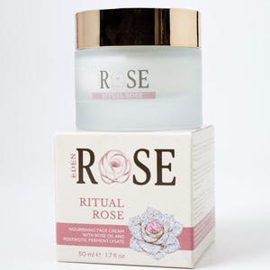 May include: A frosted glass jar of Eden Rose Ritual Rose nourishing face cream with a gold lid, sitting atop its square cardboard box. The packaging features the text "Eden Rose Ritual Rose" and "50 ml 1.7 fl oz" with a rose illustration.