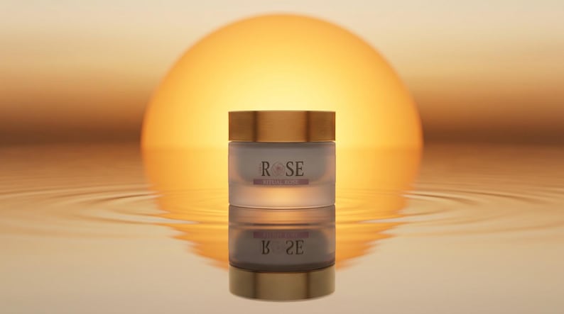 May include: A cylindrical cream jar with a frosted glass body and a metallic gold lid. The label on the front features the text ROSE in a dark font with a small rose icon between the letters, and the words PETAL ROSE printed below in smaller text.