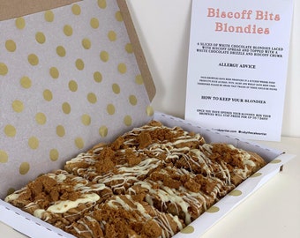 May include: A white box with gold polka dots contains six slices of white chocolate blondies topped with biscoff spread and white chocolate drizzle. The box includes a card with the text "Biscoff Bits Blondies", "6 slices of white chocolate blondies laced with biscoff spread and topped with a white chocolate drizzle and biscoff crumb.", "Allergy Advice", "Your brownies have been produced in a kitchen where food products such as eggs, nuts, dairy and wheat have been produced. Therefore please be aware that traces of these could be found.", "How to keep your blondies", "Once you have opened your blondies box your brownies will stay fresh for up to 7 days.", "keartist.com @rubythecakeartist".