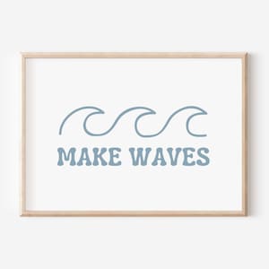 May include: A framed print featuring a blue wave design and the text "MAKE WAVES" in a retro font.