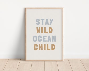 May include: A framed print with the text "STAY WILD OCEAN CHILD" in a light blue and brown color scheme.