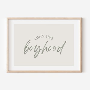 May include: A framed print with a beige background and the text "Long Live Boyhood" in grey script.