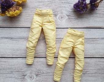May include: Two pairs of yellow trousers with a slightly distressed look. The trousers are made of a soft, stretchy fabric and have a relaxed fit.