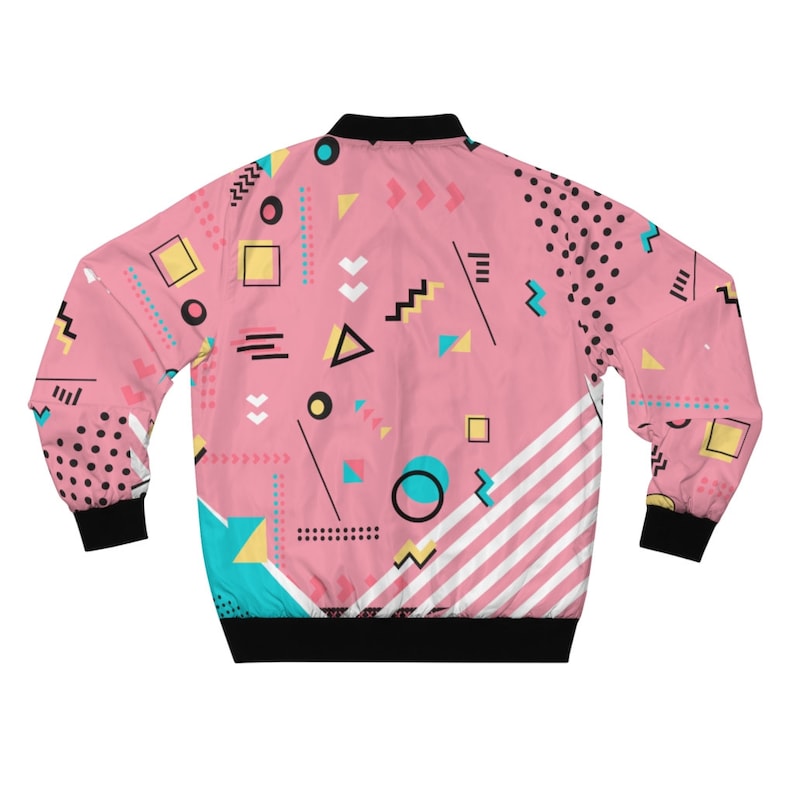 May include: A pink bomber jacket with a geometric pattern featuring various shapes, colors, and lines. The pattern includes circles, squares, triangles, and zigzags in shades of pink, yellow, blue, and black.