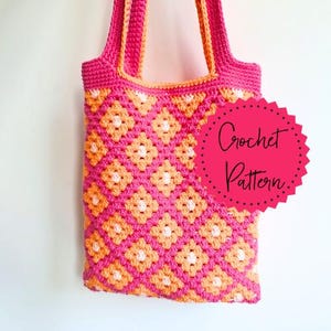 May include: A handmade crochet tote bag in a vibrant pink and orange floral pattern. The bag features a repeating diamond pattern with white centers and a solid pink border and straps. The text "Crochet Pattern" is on a pink circle.