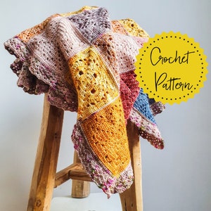May include: A multi-colored crochet blanket with a scalloped edge, draped over a wooden stool. The blanket is made of different colored squares, including pink, red, blue, and yellow. The text "Crochet Pattern" is written on a yellow circle.
