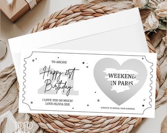 Puede incluir: Un boleto de cumpleaños rectangular blanco con texto negro que dice To Archie Happy 21st Birthday I Love You So Much Love Olivia XXX y una gran área gris para raspar en forma de corazón con el texto Weekend in Paris y Scratch to Reveal Your Surprise.