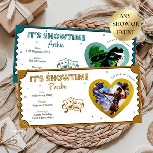 May include: Two personalised show tickets with the text "IT'S SHOWTIME" and names Archie and Phoebe. The tickets have a teal and gold border, with a heart-shaped scratch-off area. One ticket has a Wicked-themed image, the other a Come Alive image.