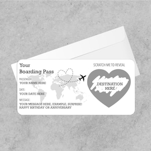 May include: A white boarding pass with a scratch-off heart revealing "DESTINATION HERE." The pass includes fields for passenger name, date, and a message. A dotted line with a heart and airplane graphic is also present.