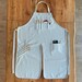 Pottery Apron with Split Leg and Pockets for Pottery Tools. Perfect for Working with Clay made with Canvas Material in Light Grey. 