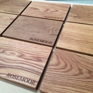 May include: A set of six wooden cutting boards with the word "Rosemoor" engraved on each board.