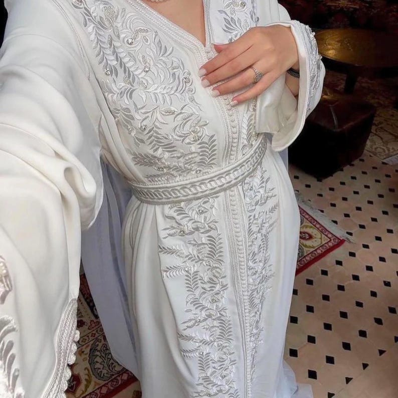 Detailed embroidery on white Moroccan caftan belt, luxury Moroccan bridal fashion