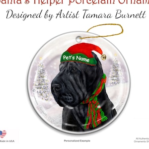 May include: A round porcelain Christmas ornament featuring a black Shar Pei dog wearing a red and green Santa hat and scarf. The ornament has the text "Pet's Name" on the hat and "Santa's Helper Porcelain Ornament" at the top. Designed by Artist Tamara Burnett.