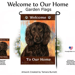 May include: A garden flag featuring a detailed portrait of a brown dog with long, wavy fur and amber eyes. The flag has the text "Welcome to Our Home" and paw prints at the top and bottom. The artwork is by Tamara Burnett.