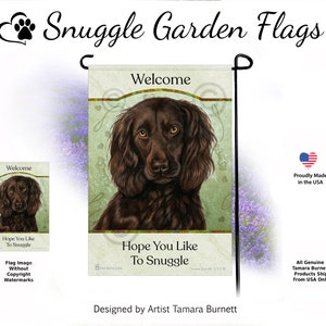 May include: A garden flag featuring a brown dog with a welcoming message. The flag has the text "Welcome" at the top and "Hope You Like To Snuggle" at the bottom. The flag is designed by artist Tamara Burnett and proudly made in the USA.