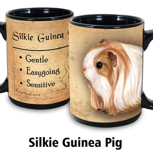 May include: Black ceramic mug with a brown and white illustration of a Silkie Guinea Pig. The mug has a black handle and the text "Silkie Guinea Pig" and "Gentle, Easygoing, Sensitive" on the front.