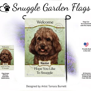 May include: A garden flag with a brown dog illustration, the text reads "Welcome" and "Hope You Like To Snuggle." The flag has a light green background with heart and paw print details. Made in the USA, the flag is designed by Artist Tamara Burnett.