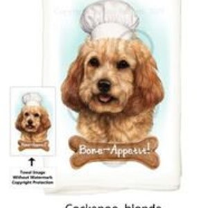 May include: A kitchen towel featuring a blonde Cockapoo dog wearing a white chef's hat. The dog is smiling and has a bone-shaped sign that says "Bone Appetit!" in front of it.