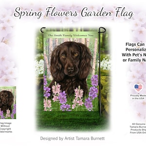 May include: A garden flag featuring a brown dog with a welcoming message. The flag has a green background with purple and pink flowers. Text at the top reads "Spring Flowers Garden Flag". The flag is designed by Artist Tamara Burnett and proudly made in the USA.