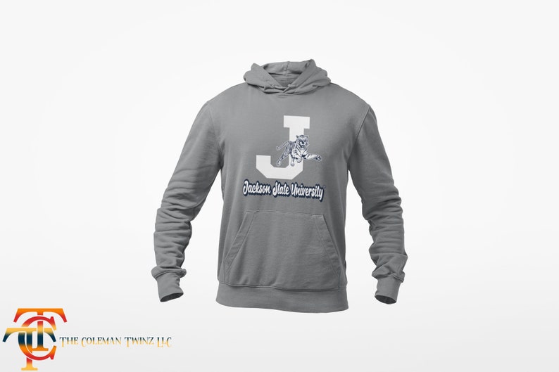 May include: A gray hooded sweatshirt with a white letter J and a white tiger graphic. The text "Jackson State University" is printed in navy blue below the graphic.
