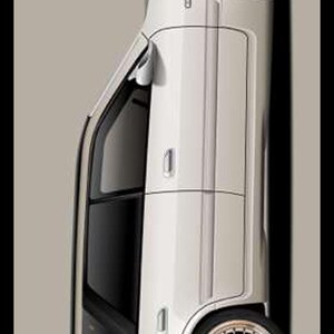 May include: A skateboard deck featuring a light beige background and a white sedan illustration in profile. The car has gold multi-spoke wheels and tinted windows. The text "TOOL DYE" with a checkered flag icon is printed at the top center.